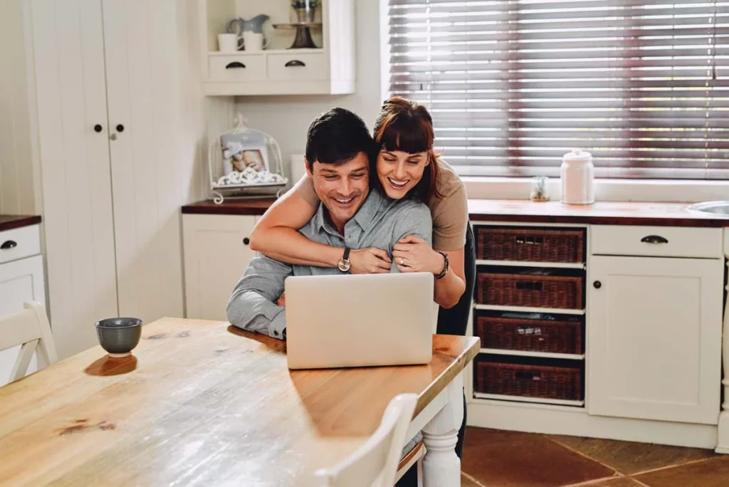 Homeowners using a laptop to request a free house cleaning quote online